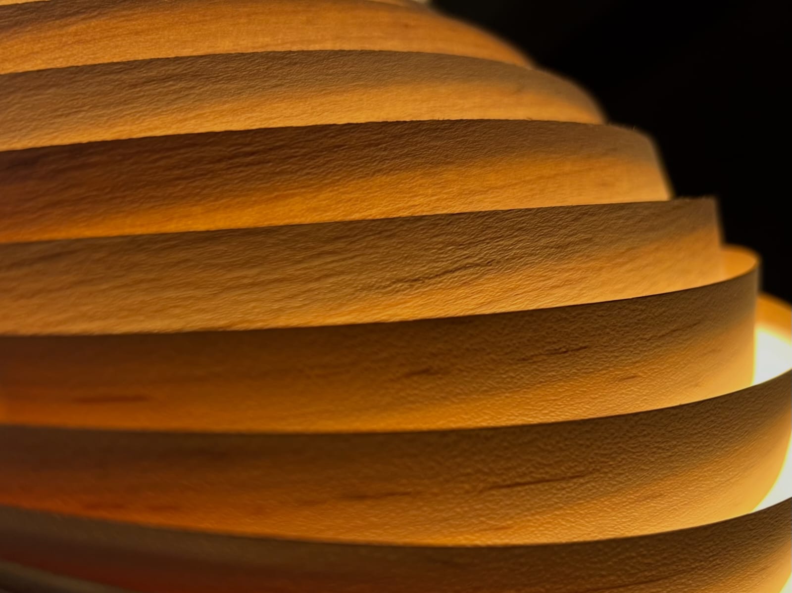 Looking down into a tiered concrete atrium with walkways and a central plaza