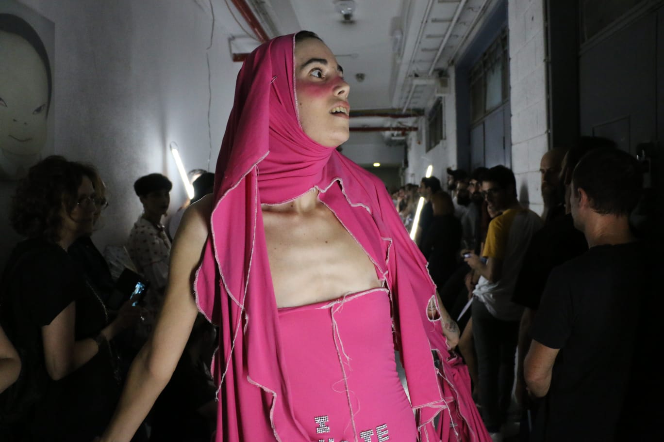Layered wooden veneer lamp glowing warm orange against a black background